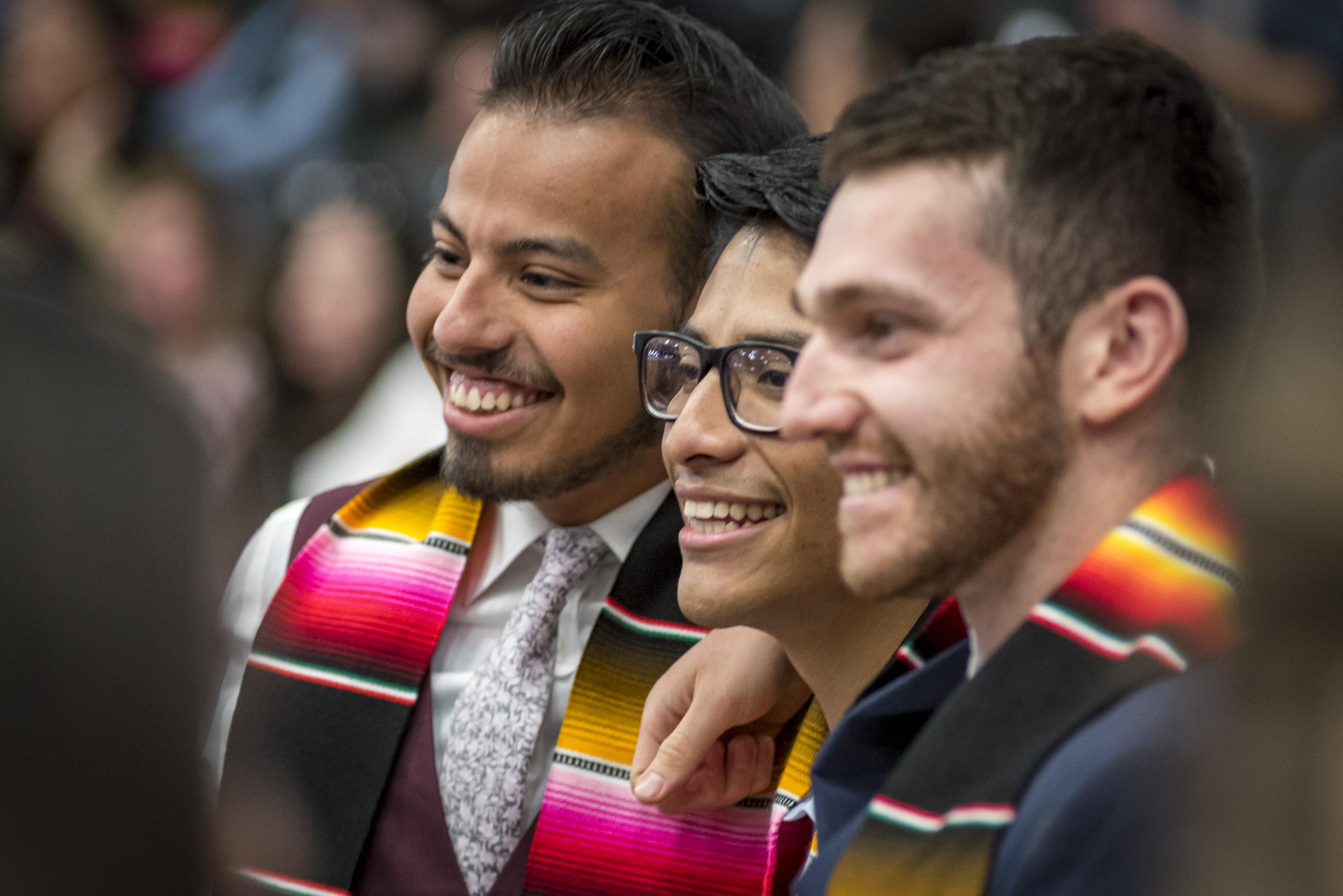 Three graduates smiling at the MSU Denver Latinx Graduation.