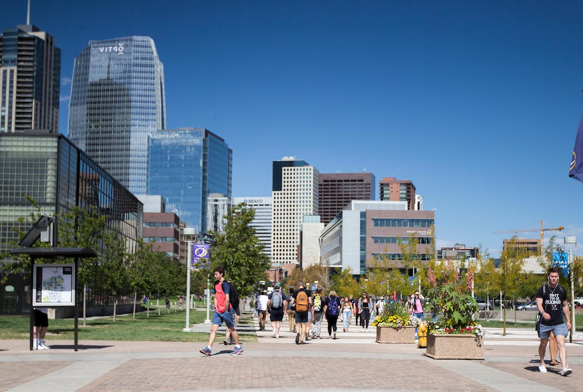 Outside summertime image of student on our downtown Denver campus