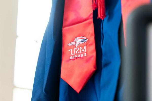 A picture of a cap and gown, zoomed in on the red regalia